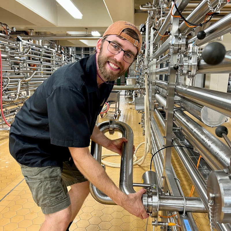 Cellar worker connecting pipes.