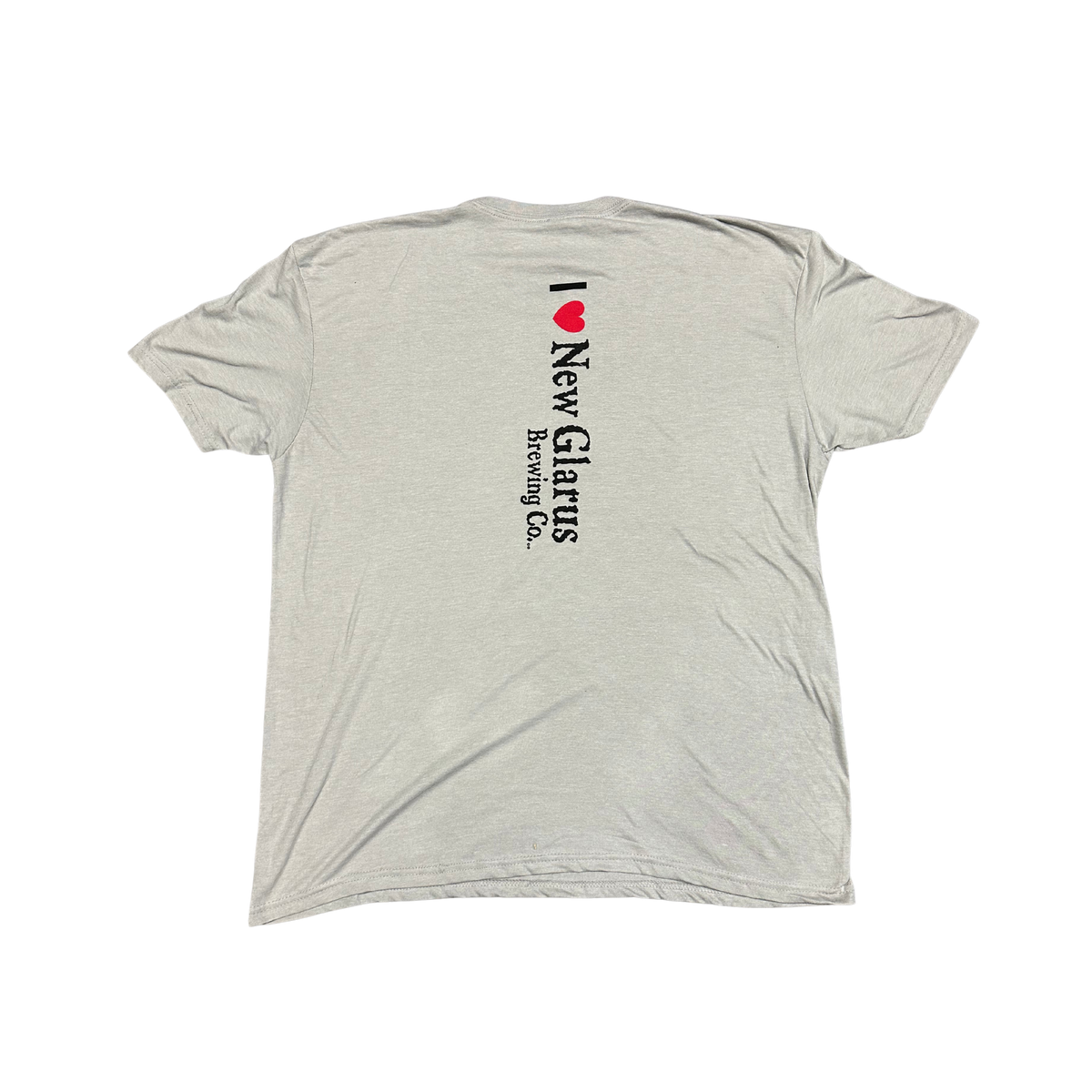 Back of a light gray New Glarus Brewing Co. T-shirt featuring a vertical “I ❤️ New Glarus Brewing Co.” graphic in black and red centered on the upper back.