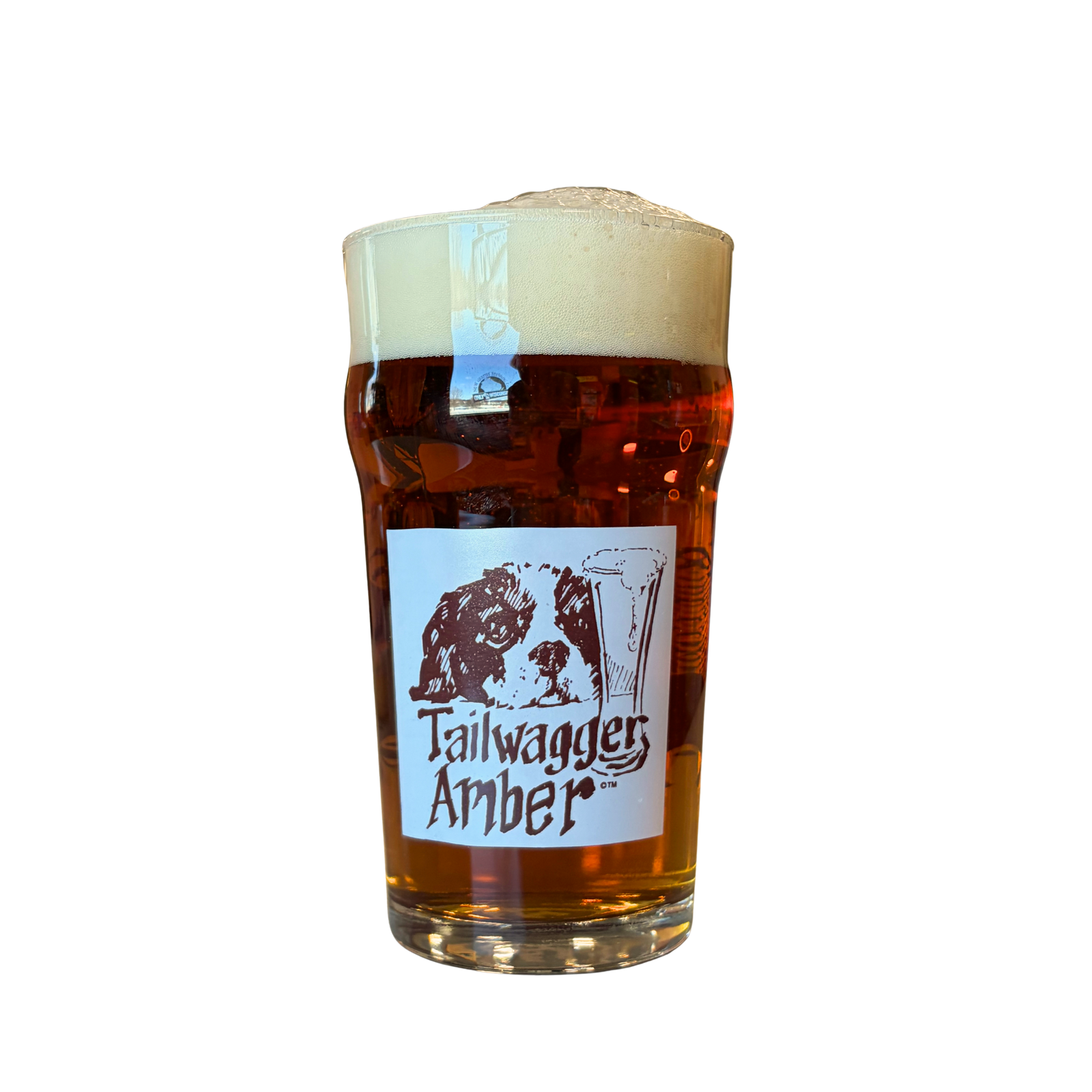Pint glass of Tailwagger Amber beer with a white label background and Tailwagger logo in front. On back is our Only in Wisconsin logo in brown. 