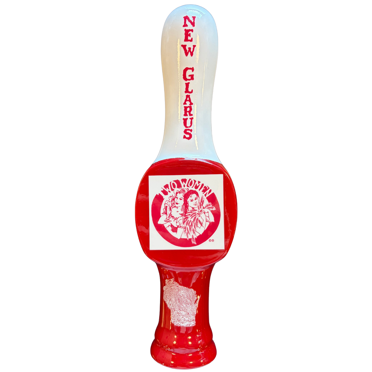 Tap handle with a smooth white handle at the top with the words "New Glarus" going down the center. The Two Women brand logo is displayed in the handles flaired mid section. Red and White coloring throughout. 