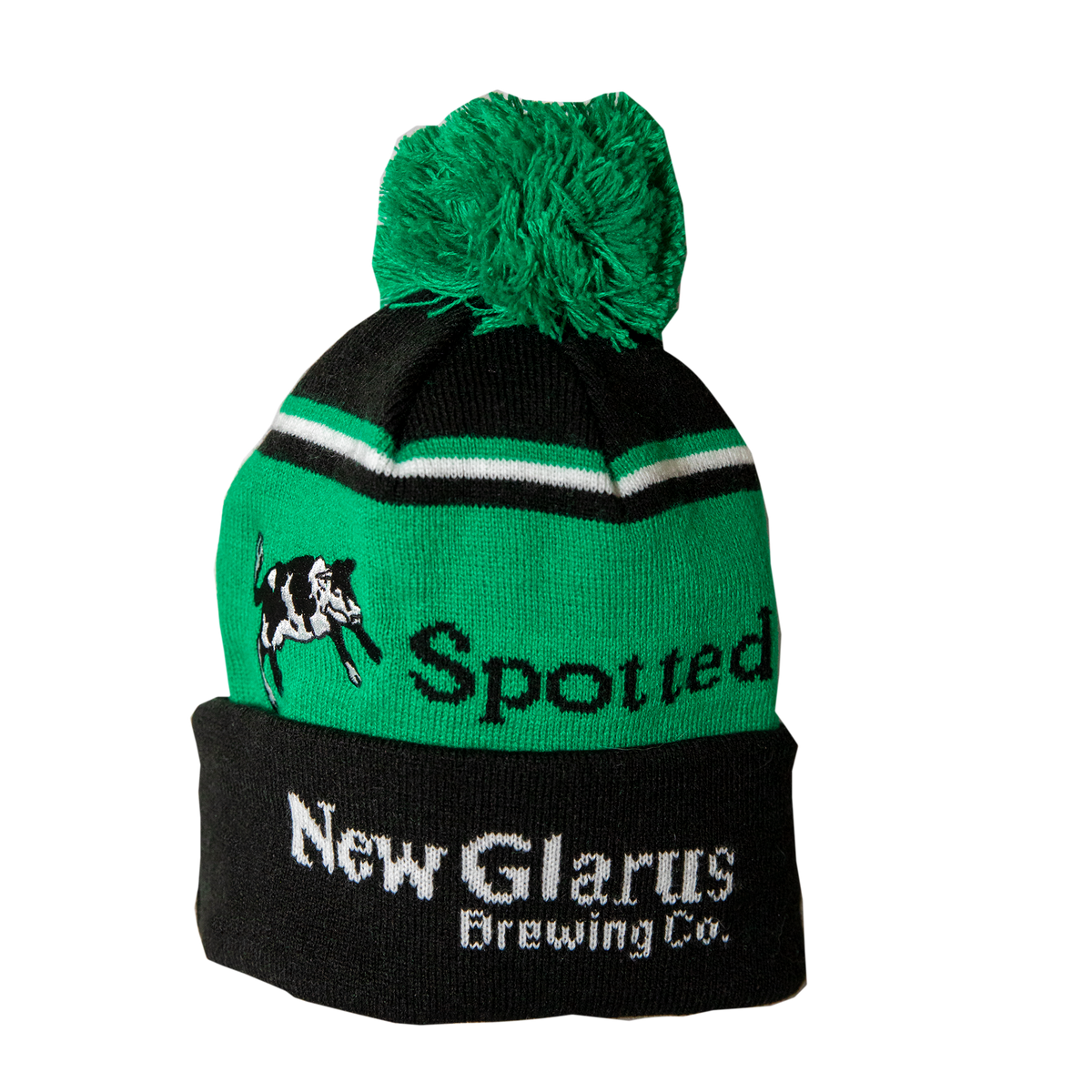 Green and black stocking hat with Spotted Cow and New Glarus Brewing Co. on it with a large green pom pom on top