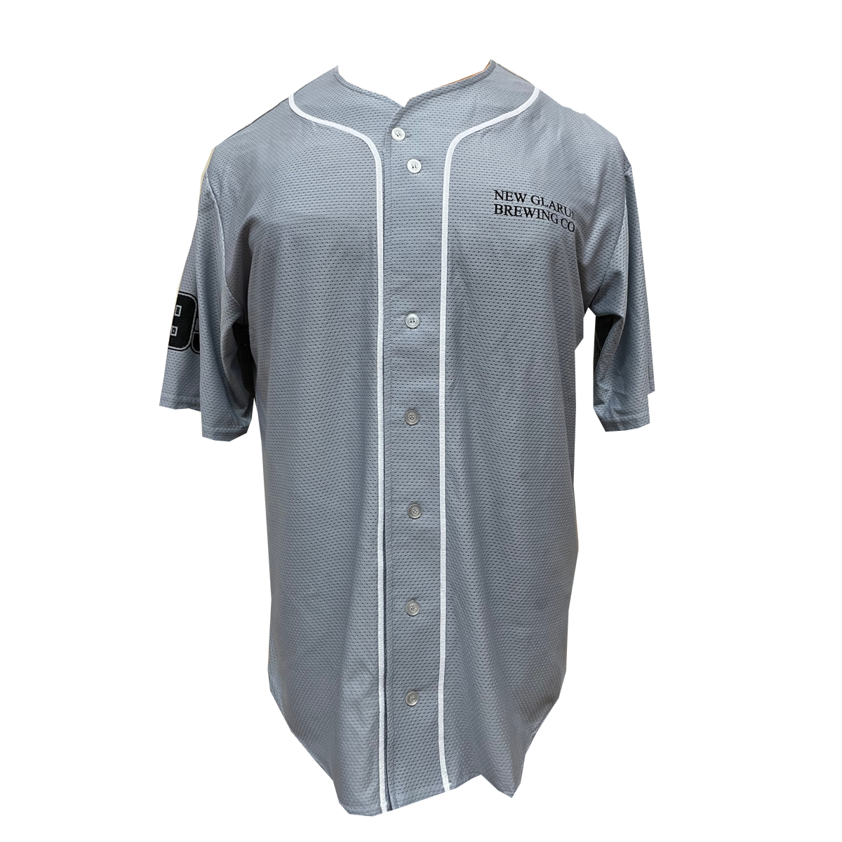 Front of a light grey button up baseball jersey with white trim on either side of the buttons and New Glarus Brewing Co. in black on the left front side.