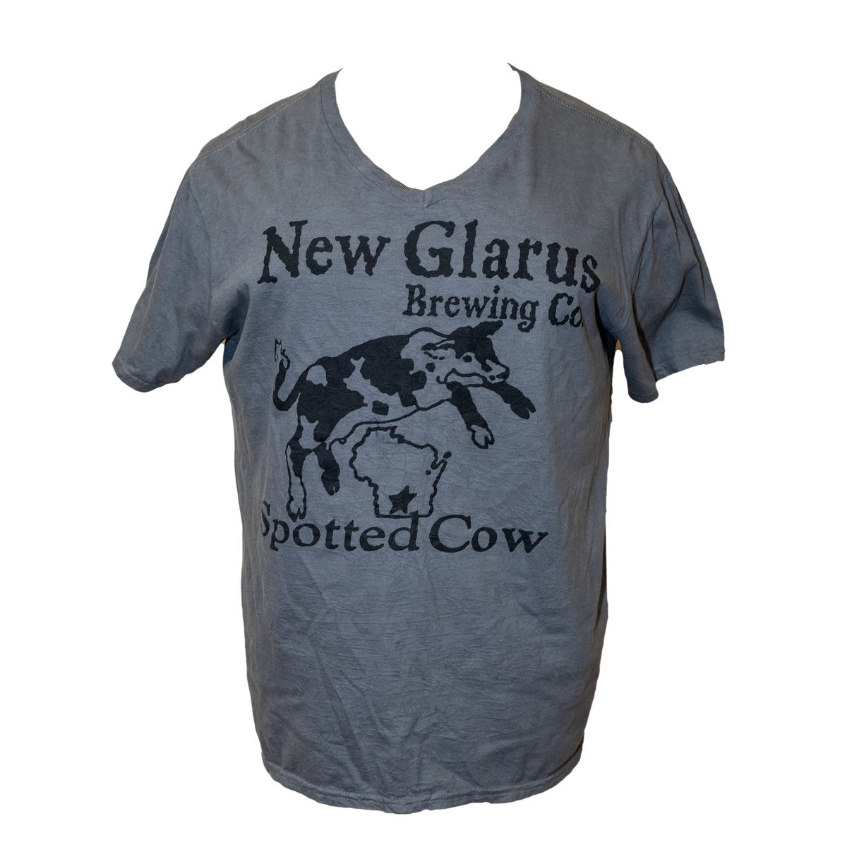 Dark Grey V-neck t-shirt with New Glarus Brewing Co. Spotted Cow logo on front in black ink. Comes packaged in the shape of a Spotted cow beer bottle. 